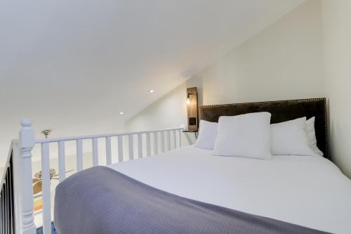a white bed with white pillows in a bedroom at Sojourn at DuPont Place in Washington