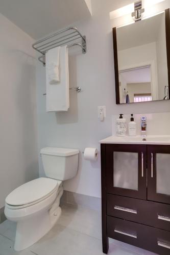 a bathroom with a toilet and a sink and a mirror at Sojourn at DuPont Place in Washington