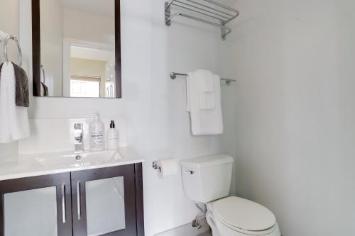 a bathroom with a toilet and a sink and a mirror at Sojourn at DuPont Place in Washington