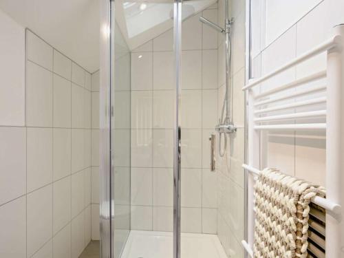 a shower with a glass door in a bathroom at The White Lady in Worstead