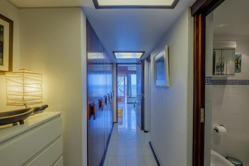 a hallway leading to a bathroom with a sink at House on the Beach in Sesimbra