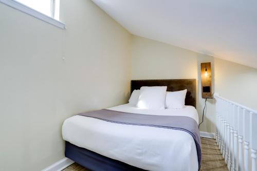 a bedroom with a large bed with white sheets at Sojourn at DuPont Place in Washington