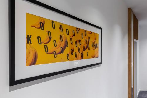 a framed picture of bananas on a wall at KONTRAKT Boutique Hotel in Kyiv
