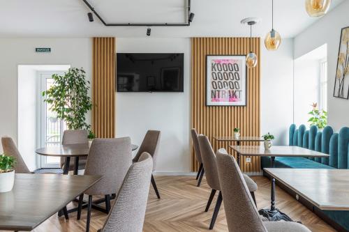 a dining room with wooden tables and chairs at KONTRAKT Boutique Hotel in Kyiv