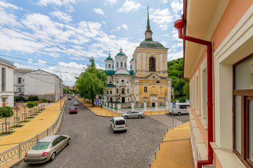 a view of a building with cars parked on the street at KONTRAKT Boutique Hotel in Kyiv
