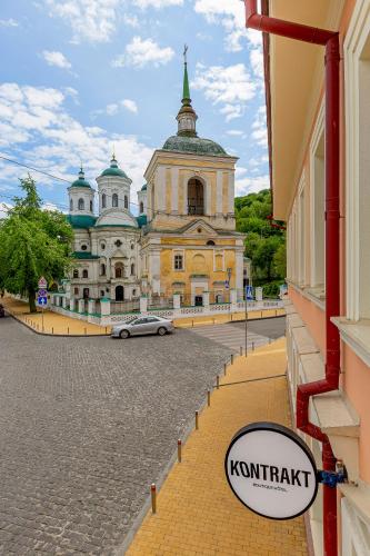 a building with a car parked in front of it at KONTRAKT Boutique Hotel in Kyiv