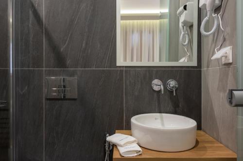 a bathroom with a sink and a mirror at MIRMA CITY Old Town in Chania
