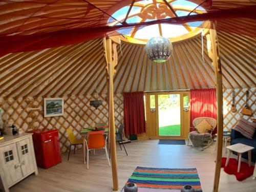 an interior of a yurt with a large tent at Overnachten in een luxe yurt! in Zonnemaire