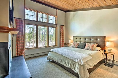 a bedroom with a bed and a large window at Beautiful Breck Townhome with Pool 1 Mi to Main St! in Breckenridge