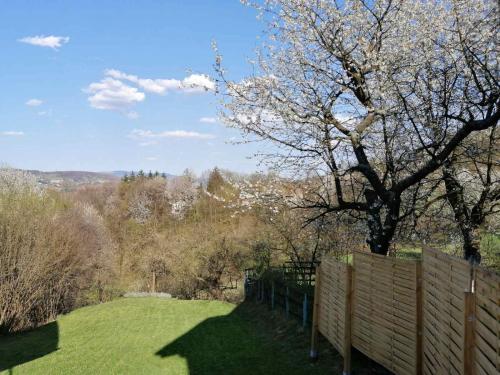 a fence in a field with a tree behind it at Ravne Rest House in Visoko