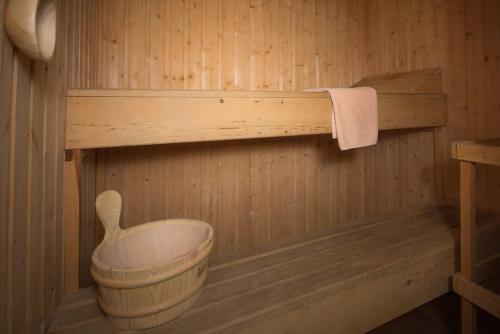 a wooden sauna with a bucket and a towel at Loch Rannoch Highland Lodge 44 in Kinloch Rannoch