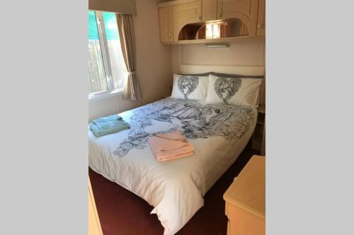 una piccola camera con un letto in una stanza di The Caravan at Ellerburn, where time stands still a Thornton Dale