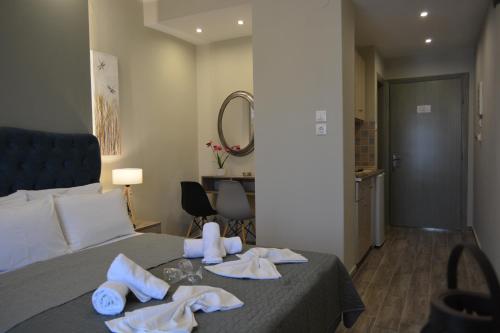 a hotel room with a bed with towels on it at Villa Georgio Paralia in Paralia Katerinis