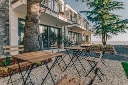 a group of tables and chairs in front of a building at Villa Salve in Badacsonytomaj