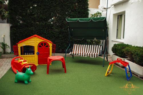 a play area with toys on the grass at Hotel Vila Mare in Durrës
