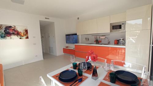 a kitchen with a table and a dining room at Blue Sky Garda - Sunset in Malcesine
