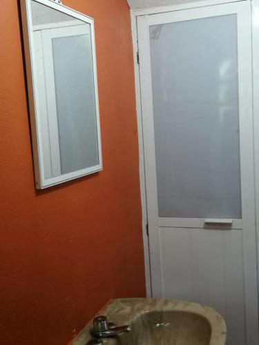 a bathroom with a sink and a mirror at Villas La Bella Margarita in Brisas de Zicatela
