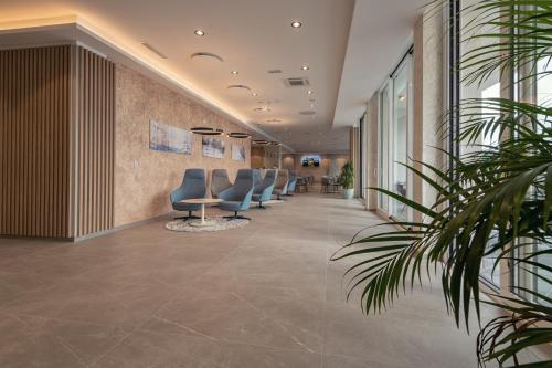 a lobby with a row of chairs and a table at Marea Hotel & Spa in Neum