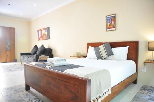 Un dormitorio con una cama grande y un sofá. en Casa Xanath, en Tulum