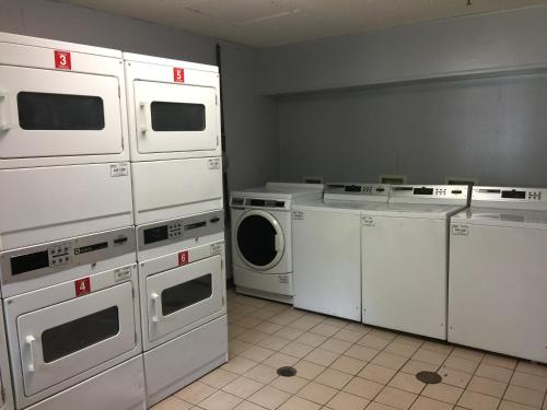 a laundry room with white washers and dryers at InTown Suites Extended Stay Memphis TN - Ridgeway Road in Memphis
