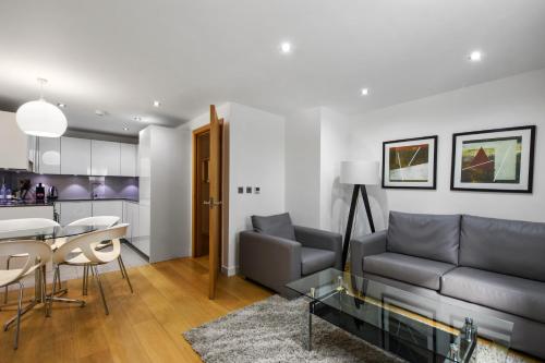 a living room with a couch and a table at Cambric by Aeria Apartments in London