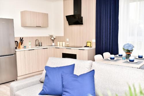 a living room with a white couch and a kitchen at VIP Apartament 11 in Lublin