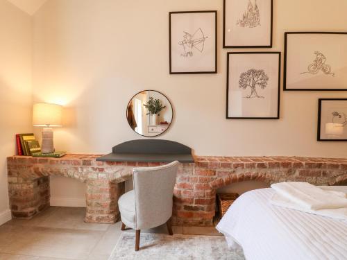 a room with a brick fireplace and a mirror at Carver's Rest in Farnsfield