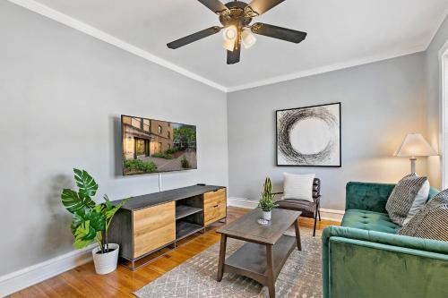 a living room with a couch and a ceiling fan at Chic 1BR Apt Close to Everything - Marshfield E3 in Chicago
