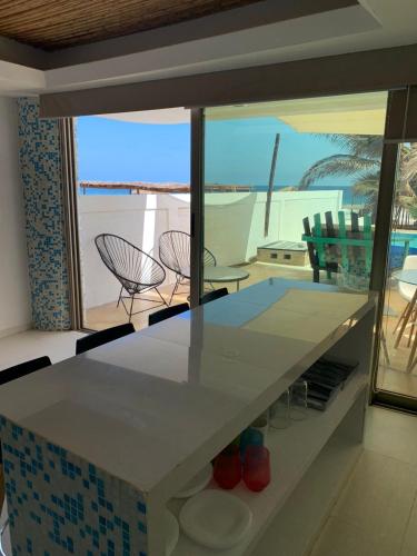 a kitchen with a counter with a view of the ocean at Condominio Agave del Mar in Coyuca