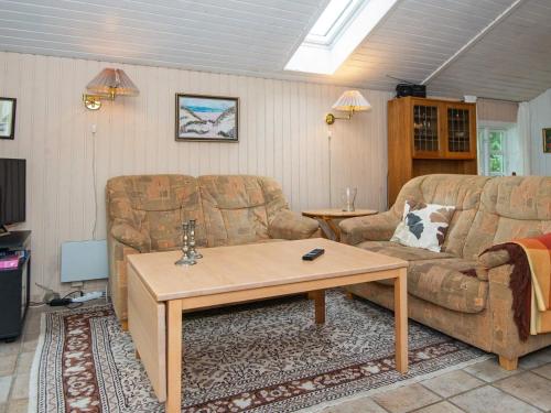 a living room with two couches and a coffee table at 4 person holiday home in Hemmet in Hemmet