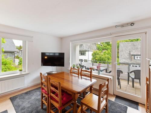 a dining room with a table and a large window at Beautiful Holiday Home in Winterberg near Ski Slopes in Winterberg