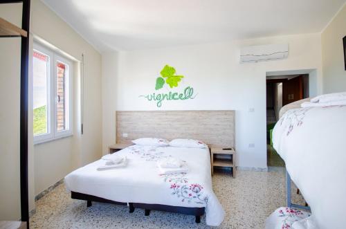 a bedroom with two beds and a sign on the wall at Girastrittue Colobraro in Colobraro