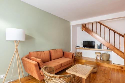 a living room with a couch and a tv at La maison d'à côté 3 - 6 people - 3 bedrooms - 2 bathrooms in Honfleur