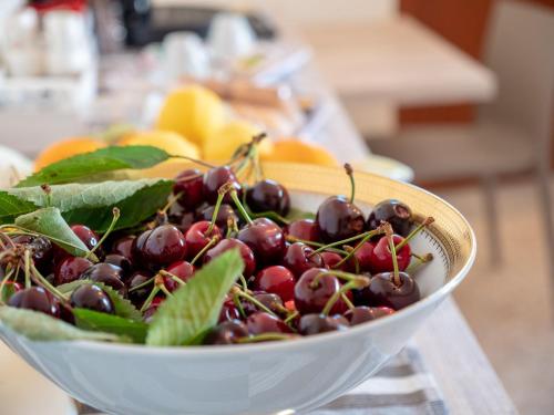 a bowl of cherries sitting on a table at Girastrittue Colobraro in Colobraro