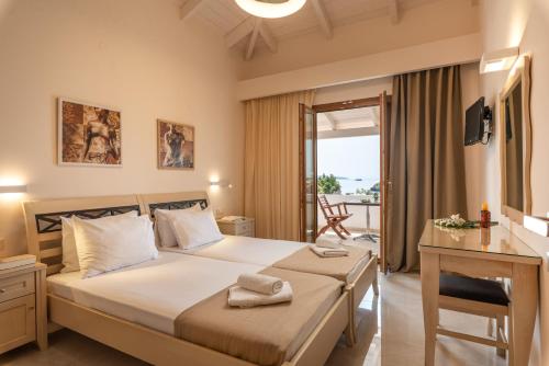 a bedroom with a large bed and a balcony at Krioneri Beach in Parga