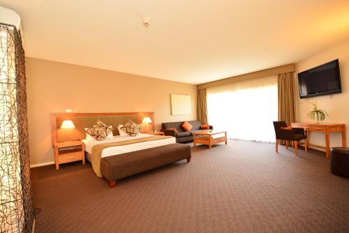 a hotel room with a bed and a couch at Mornington Hotel in Mornington