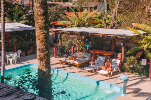 a resort with a swimming pool and a bar at Hotel Ferrugem Eco Village in Garopaba