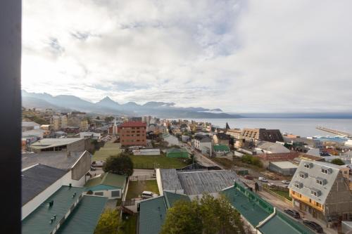 an aerial view of a city with mountains in the background at Austral Departamentos in Ushuaia