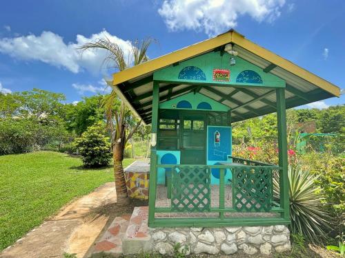 a small kiosk with a roof on top of it at Judy House 2 - Lewis Backpacker Hostel in Little Bay