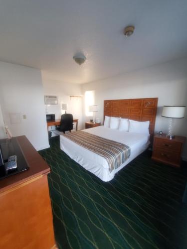 a hotel room with a bed and a desk at Bayview Lakefront Inn in Saint Ignace