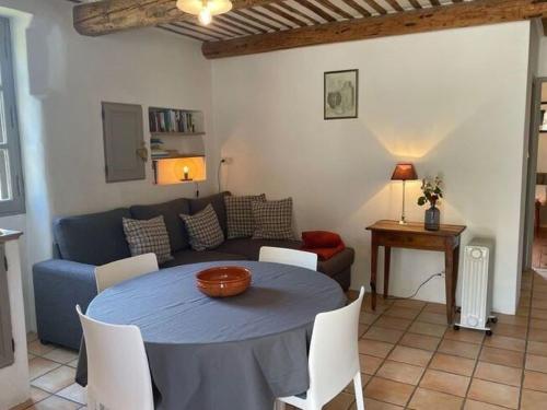 a living room with a blue table and a couch at Stylish house with heated pool in Lacoste in Lacoste