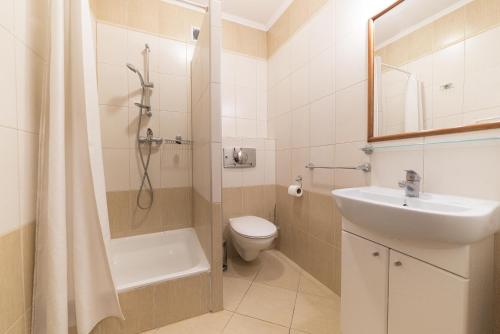 a bathroom with a shower and a toilet and a sink at Willa Solmare in Władysławowo