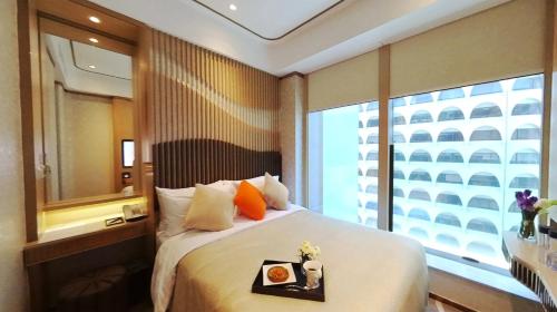 a hotel room with a bed and a window at Burlington Hotel in Hong Kong