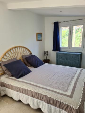 une chambre avec un grand lit avec des oreillers bleus dans l'établissement Casa San Niolo, à Cervione