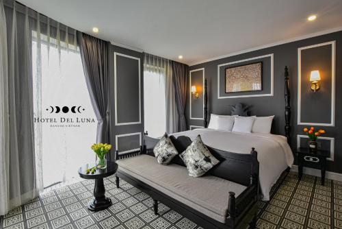 a bedroom with a large bed and a couch at Hotel Del Luna Boutique in Da Nang