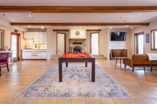 a living room with a table and a fireplace at Beach Villa Home - Walk to Beaches Trails Restaurants Activities & more in Half Moon Bay