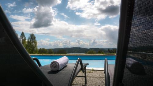 a towel sitting on a table next to a pool at Siljansnäs Hotell in Siljansnäs
