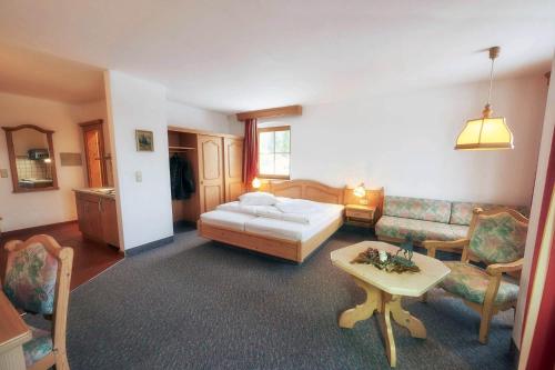 a living room with a bed and a couch at Ferienappartements Rausch in Presseck