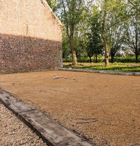 a group of ducks sitting on the ground next to a brick wall at Hofstede Ter Biest in Zwalm