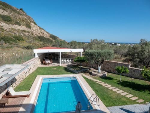 a villa with a swimming pool and a backyard at Village View Afandou in Afantou